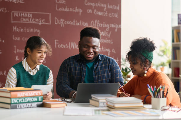 istock Group of Three Black People in College Class Looking at Laptop 1979999782