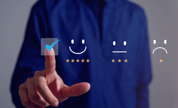 istock Business man Is using a smartphone And he is pressing face emoticon smile in satisfaction on virtual touch screen.Customer service evaluation concept. 1980006638