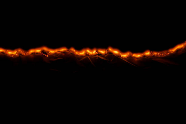 burning paper, glowing edge of paper on a black background