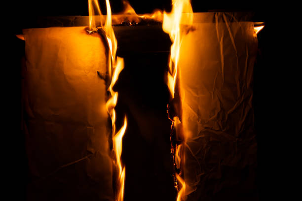 istock burning paper, glowing edge of paper 1980021439