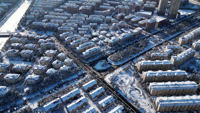 Aerial View of Winter Cityscape Amidst Heavy Snowfall