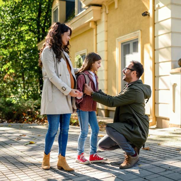 istock Mother and father taking their daughter to school 1980028880