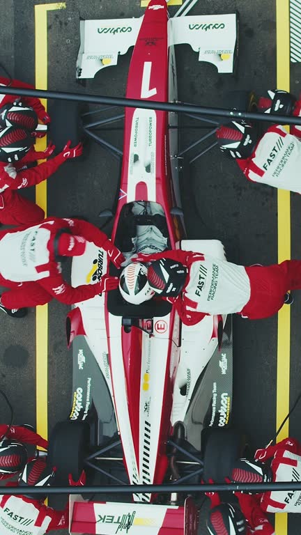 Racing team repairing racecar at pit stop