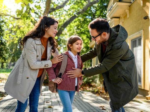 istock Mother and father taking their daughter to school 1980056280