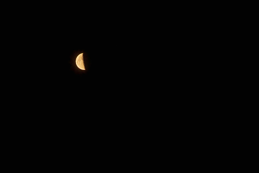 One half moon in the dark sky.Night Evening Sky Blue Moon.Copy space.Soft focus.Blurred image.