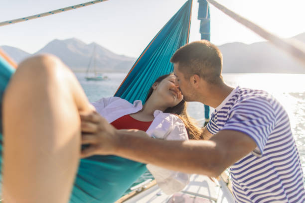 istock Young couple on sailboat 1980087351