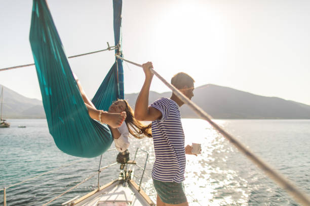istock Young couple on sailboat 1980088493