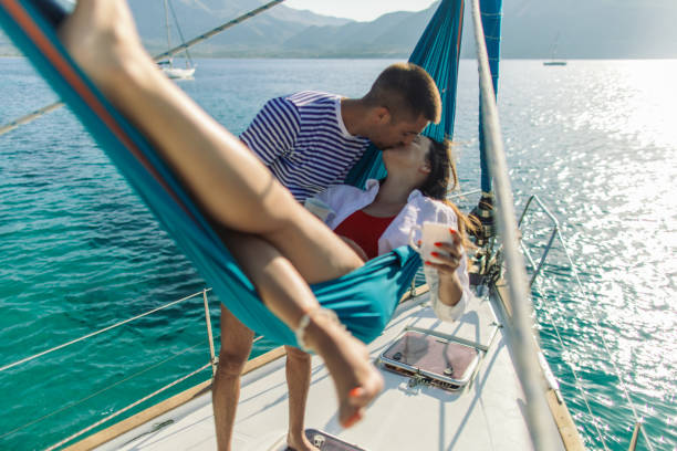 istock Young couple on sailboat 1980088882