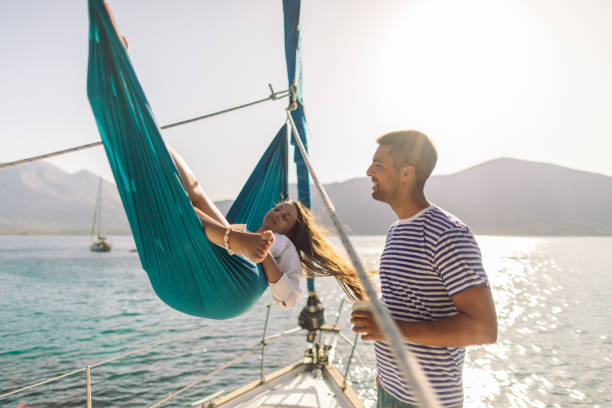 istock Young couple on sailboat 1980089033