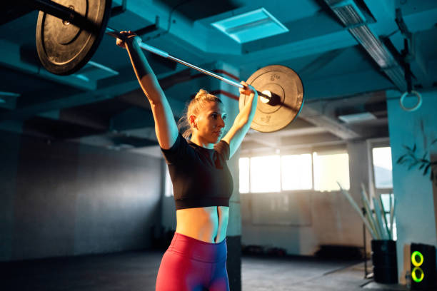 istock In the gym, female athlete exercise with barbell 1980102918