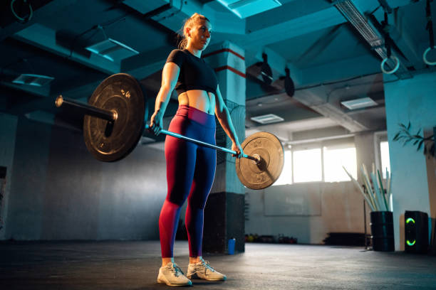 istock In the gym, female athlete exercise with barbell 1980102922