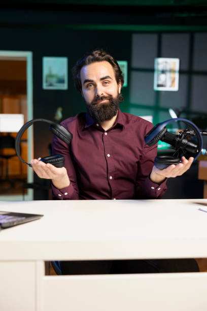 istock Media star hosts internet show, comparing music listening devices from different price ranges 1980104572