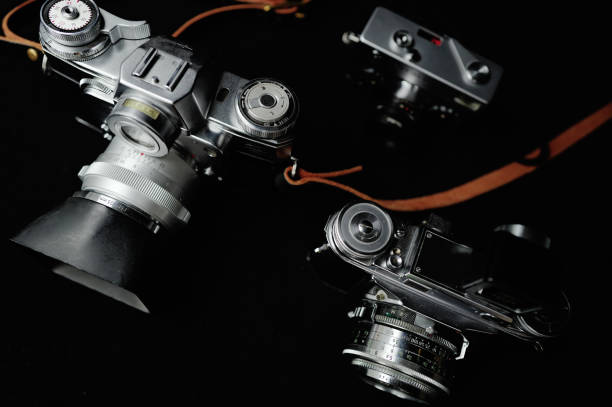 A close-up view showcasing three classic film cameras produced half a century ago, capturing the vintage charm of photography technology.