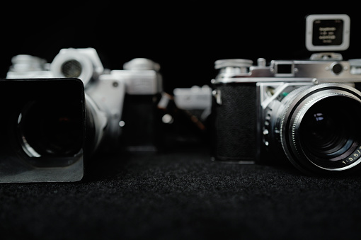 A close-up view showcasing three classic film cameras produced half a century ago, capturing the vintage charm of photography technology.