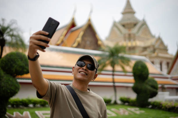 istock man taking selfie when  Exploring The Grand Palace in Bangkok 1980113863