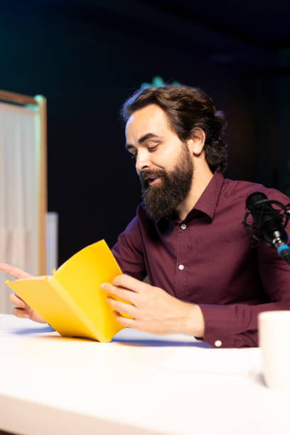 istock Content creator does influencer marketing, doing new author novel product placement in studio 1980122086