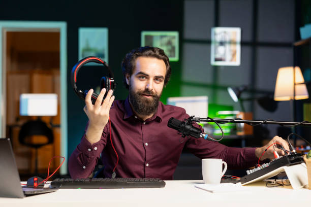 istock Tech expert testing headphones, review them for online streaming platforms 1980123239