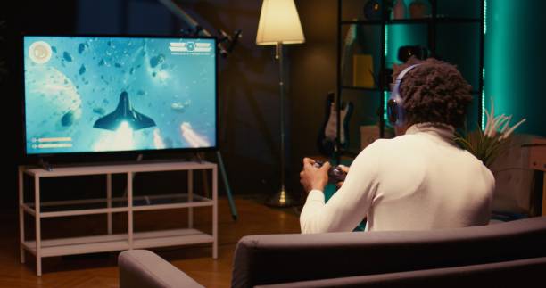 istock Player enjoying high quality ray tracing graphics on console system, jib down shot 1980128689