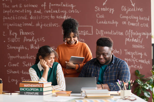 istock Three Black College Students Looking at Laptop 1980140394