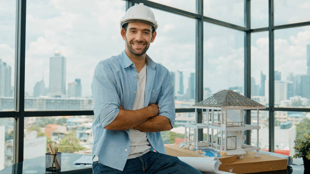 istock Portrait of skilled engineer smiling at camera while crossing arms. Tracery 1980148065