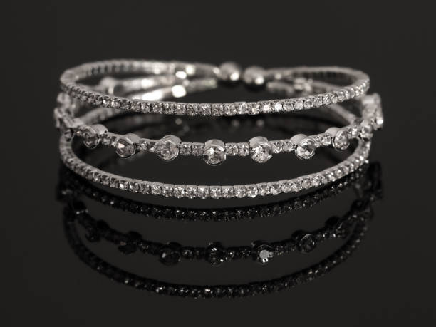 istock Silver bracelet with stones on a black background with reflection 1980152617