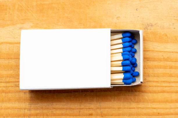 istock Cardboard box with matchsticks on wooden background, blank space top view. Space for design,flat lay copy space.Selective focus. 1980159685