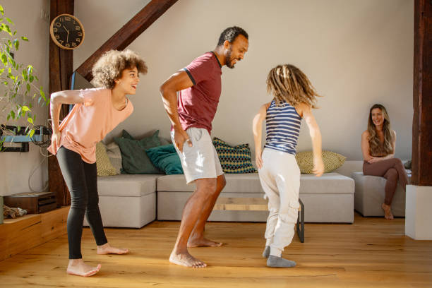 istock Father and his two children dancing at home 1980162342