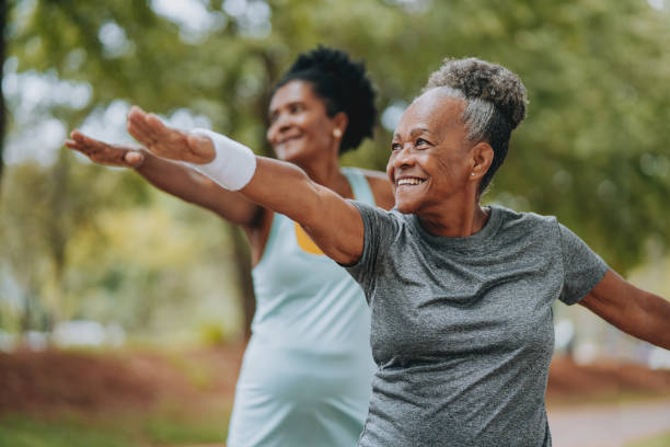 two women friends doing exercises together senior and mature - avslappningsövning bildbanksfoton och bilder