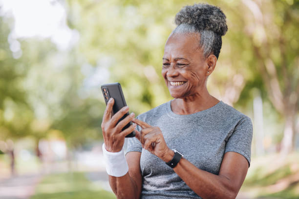 istock Senior woman holding smartphone 1980167199
