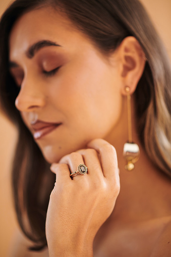 A portrait of a beautiful woman with a diamond engagement ring on her finger. Stock photo