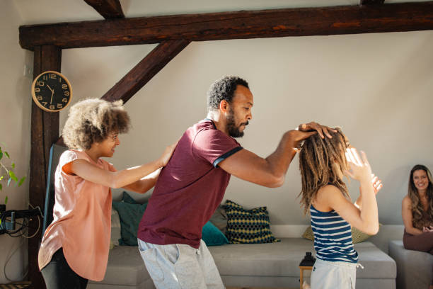 istock Father and his two children dancing at home 1980170922