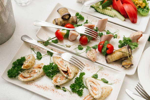 istock Snacks on white plates on a festive banquet table at a wedding. Top view 1980214160