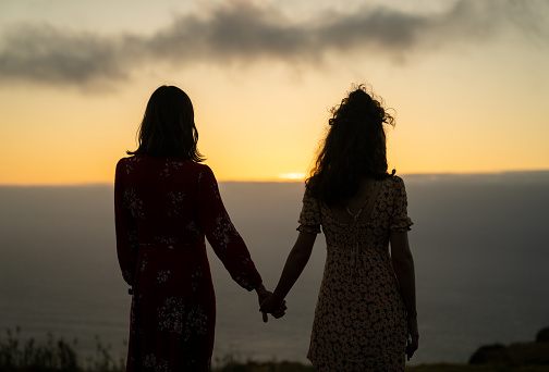 Summer vacations. Tourist couple exploring tropical Madeira and viewing the breathtaking scenery of coastline with blue sea