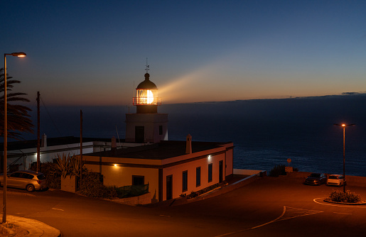 Lighthouse building on the island of Madeira in Portugal. Guiding the ships on the sea to safely return to harbor