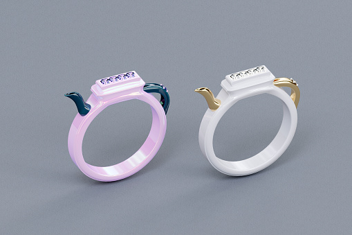 Two white diamond rings on fabric background. 3d render ceramic rings.