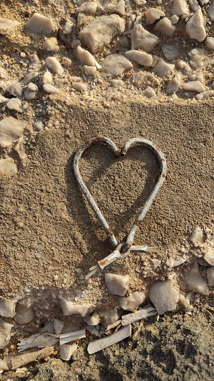 old fishing hooks on the rock in the shape of heart
