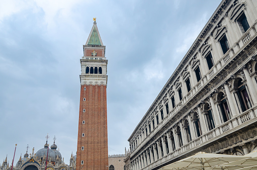 Bell tower on a Piazza di San Marco or on San Marco square, Venice, Italy and the detail of the largest public building