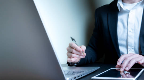 istock Businessman using digital tablet and laptop 1980301907