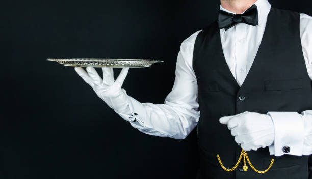 istock Butler in White Gloves Holding Serving Tray 1980309870