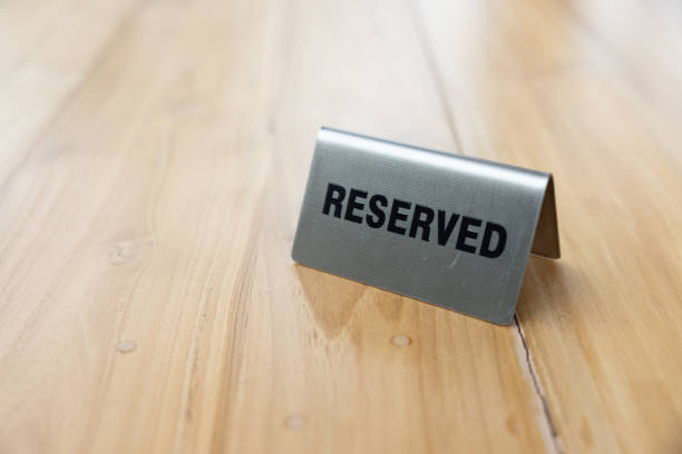 reserved sign on the wooden table in restaurant.