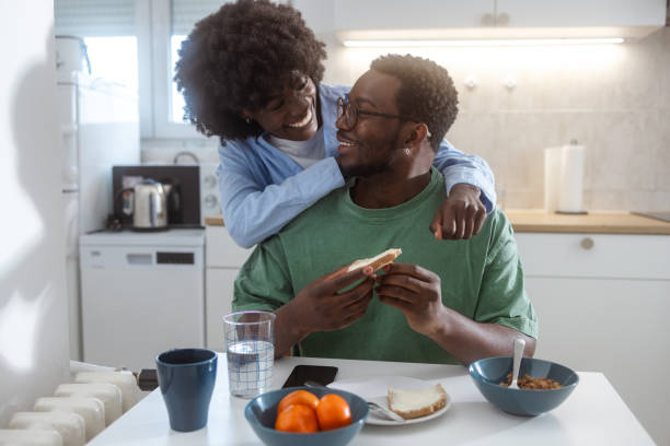 istock A Black couple hugging in the kitchen - Love and affectionate 1980317540