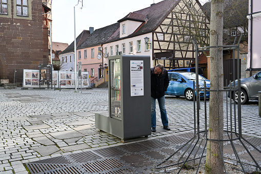 Bad Windsheim, Germany, January 25, 2024 - A public bookcase, also known as a book box or book cell, in the historic old town of Bad Windsheim, Bavaria.