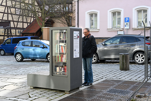 Bad Windsheim, Germany, January 25, 2024 - A public bookcase, also known as a book box or book cell, in the historic old town of Bad Windsheim, Bavaria.