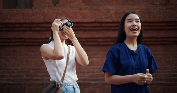 istock Young female traveler use camera, visit archaeological site with local guide 1980318818
