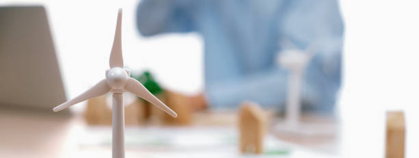 istock Windmill model and wooden block was scatter around on the table. Delineation. 1980337379
