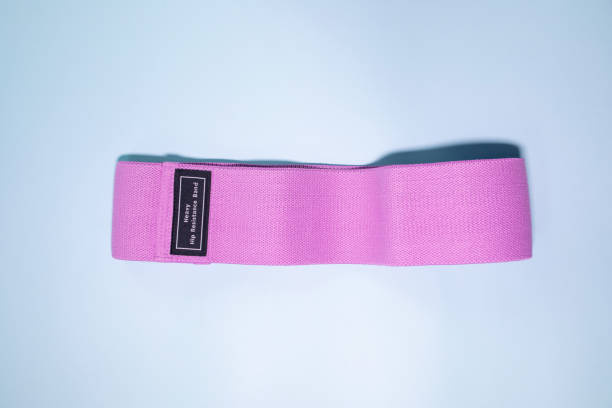 istock Multicolored exercise rubber band fitness on blue background. 1980345961