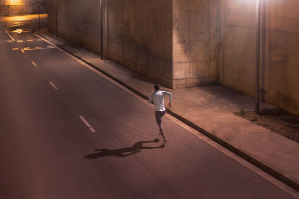 istock Challenge Run: Determined Female Athlete's Night Training for Better Results outdoors in the city 1980381002