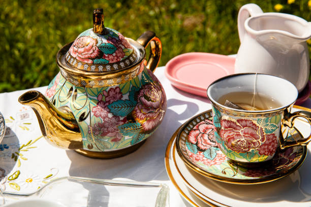 An elegant spread of traditional English afternoon tea, featuring classic finger sandwiches, scones with clotted cream and jam, and a selection of fine teas. A timeless British tradition.