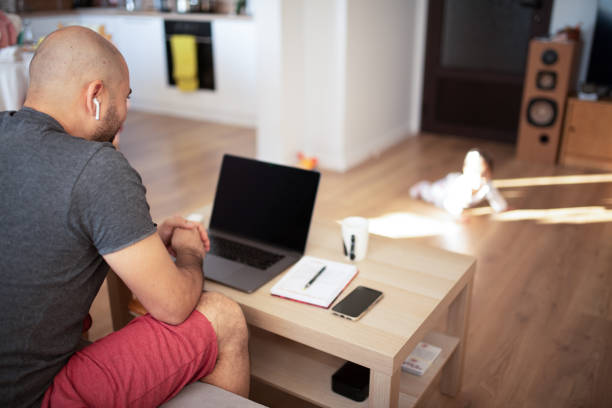 istock Adult man working from home 1980393599