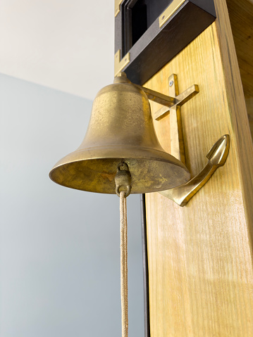 Brass bell on a wall in a house